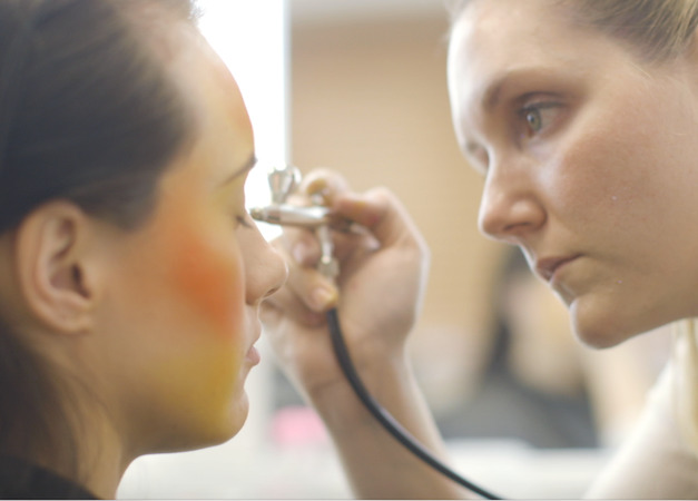 student applying airbrush make-up