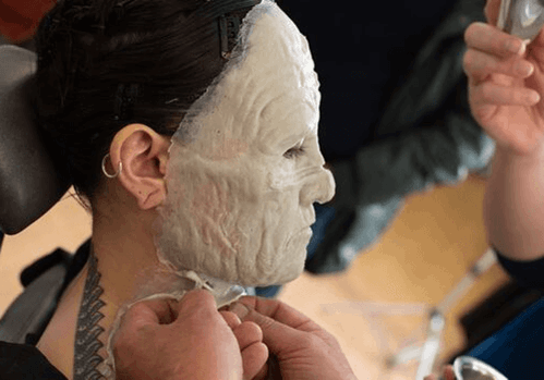 A prosthetic make-up piece being applied to a model